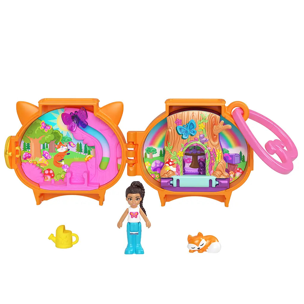 Polly Pocket Pet Connects fox locket playset in bright orange plastic shaped like a fox, opening to reveal a colorful woodland scene with rainbow treehouse, butterflies, doll, fox figure, and watering can accessory.
