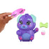 Hand placing pink sleep mask on purple Polly Pocket Puppy compact with green bow, removable popcorn accessory, and cute painted face details.