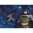 DC Batman puzzle illustration featuring Batman in grey suit with yellow utility belt, dynamic cape action, and tech blueprint background with Batmobile and Bat-symbol graphics.
