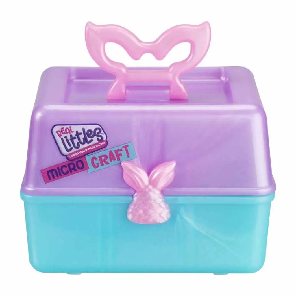 Close-up of Real Littles Micro Craft purple and teal storage box with pink mermaid tail handle and brand logo, emphasizing DIY craft toy packaging for fizz bomb creation.