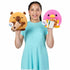 Girl in a light blue dress holding two Snackles Series 2 plush toys—a Subway platypus and a boba tea bear—showing the toy size and soft, huggable texture for kids.