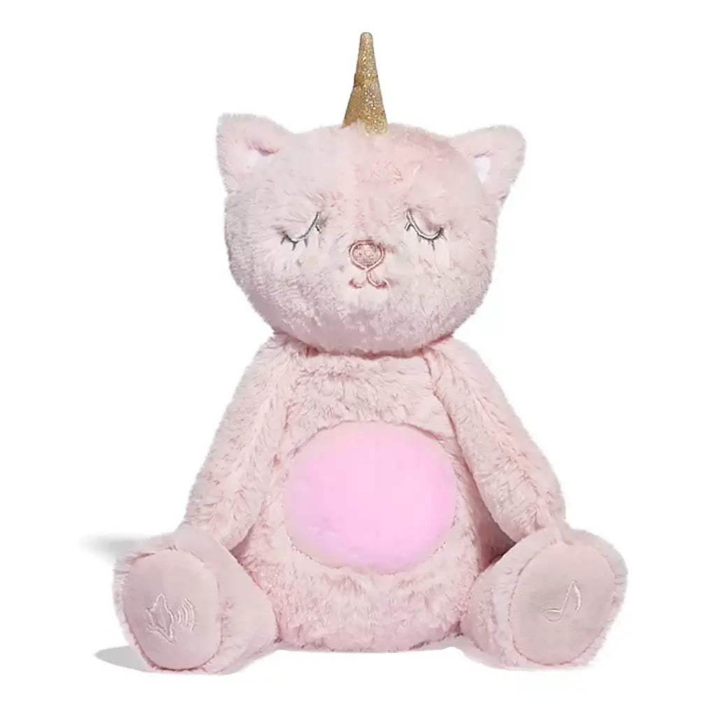 Front view of pink unicorn cat plush with golden horn, sleepy embroidered eyes, and softly glowing pink belly, seated upright on white background.