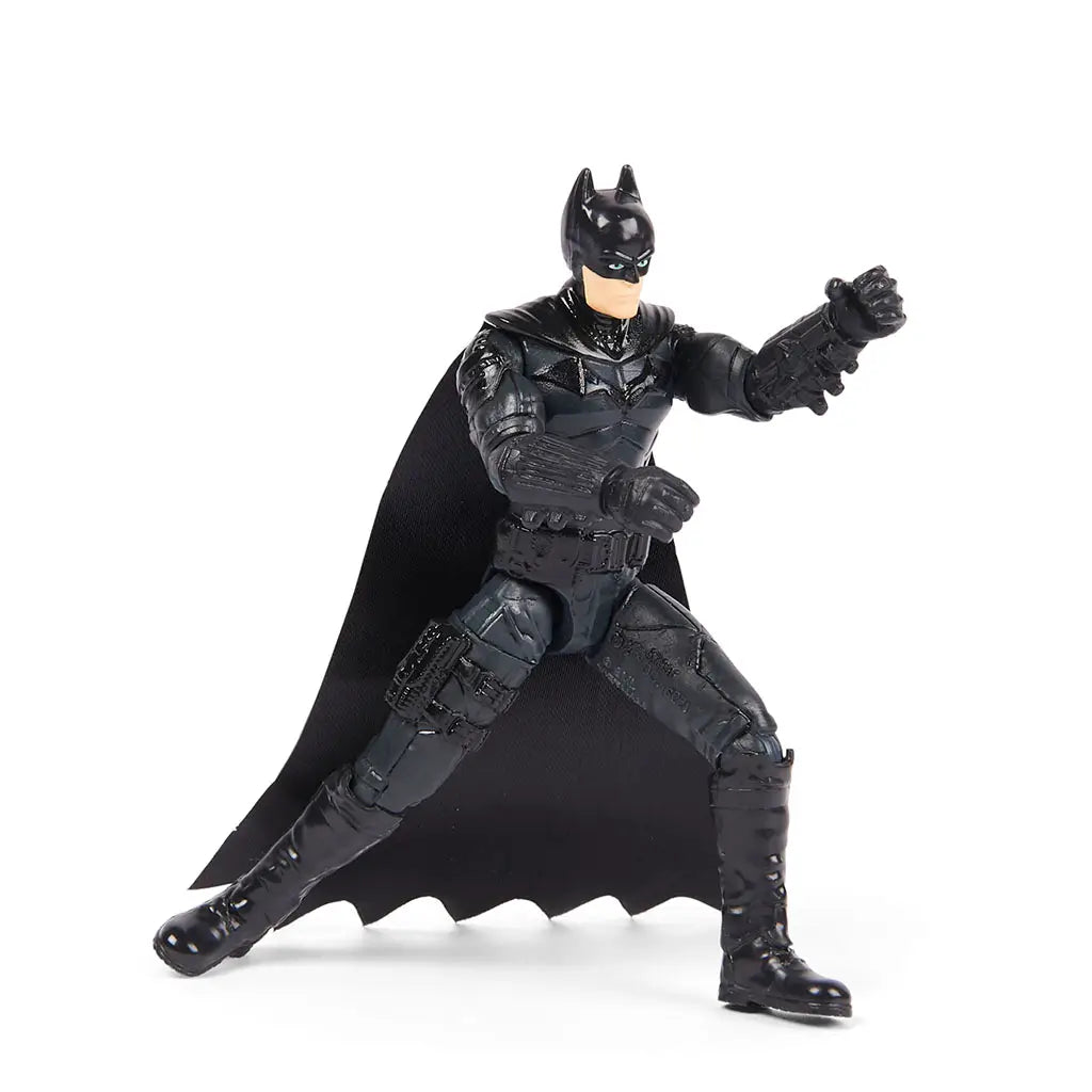 Spin Master Batman 4-inch action figure in black armored suit with cape shown in dynamic pose, ready for battle play with articulated arms, legs, and head.