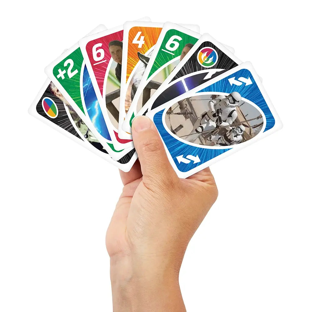 Hand holding multiple Mattel UNO Star Wars cards in play, with characters including Yoda, Rey, and Stormtroopers shown on bright colored designs.