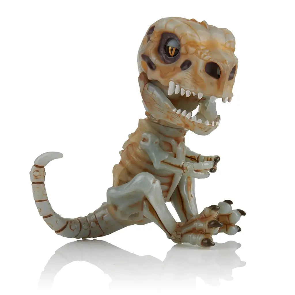 Side view of Untamed Fingerlings Doom Skeleton Dinosaur toy, showing its skeletal structure, curled tail, and snarling mouth designed to react to sound and touch with lifelike movements.