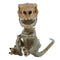 Close-up of the Untamed Fingerlings Doom Skeleton Dinosaur figure, a bone-white T-Rex with brown shading, detailed claws, and a fierce expression with sharp teeth and expressive orange eyes.