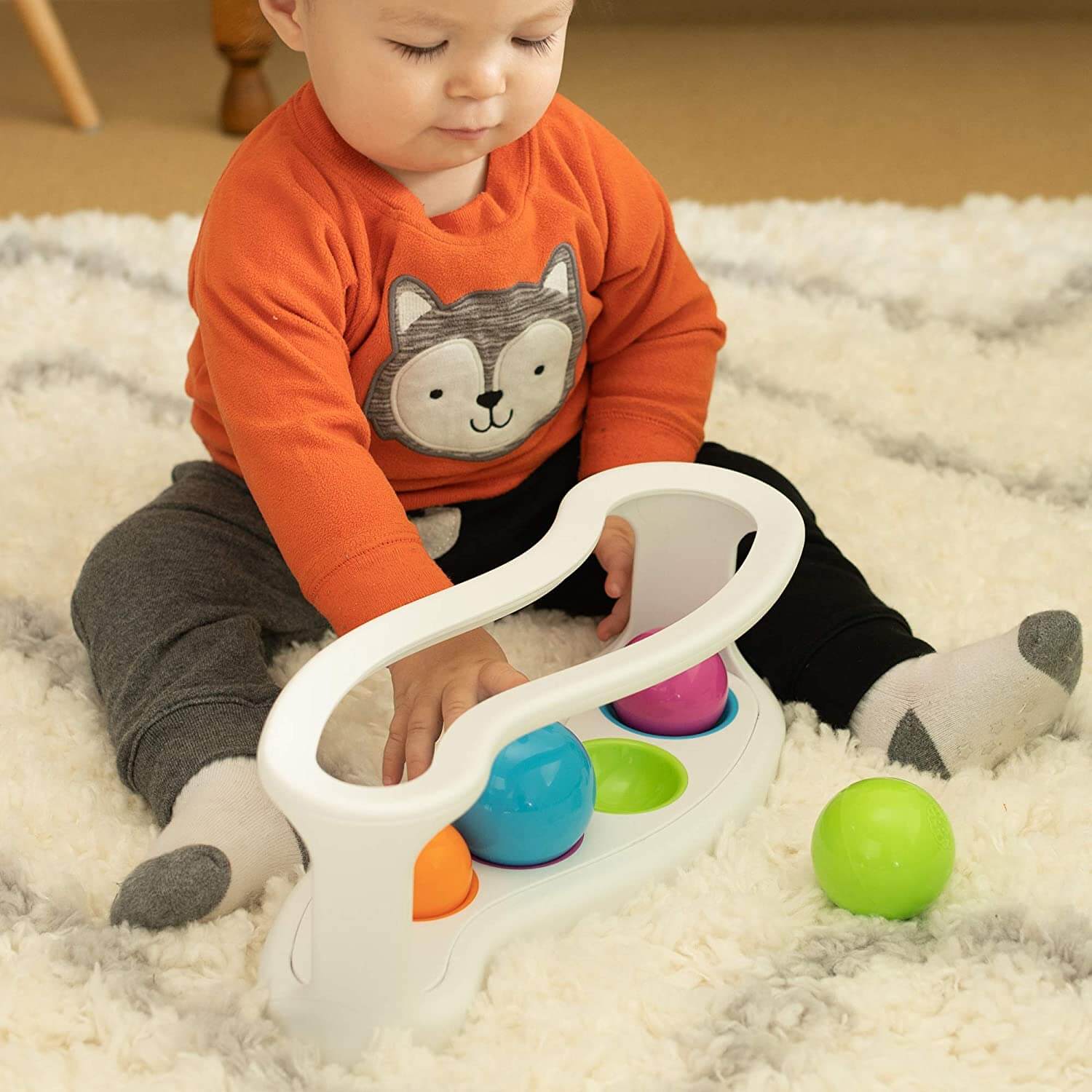 Baby playing with the toy.